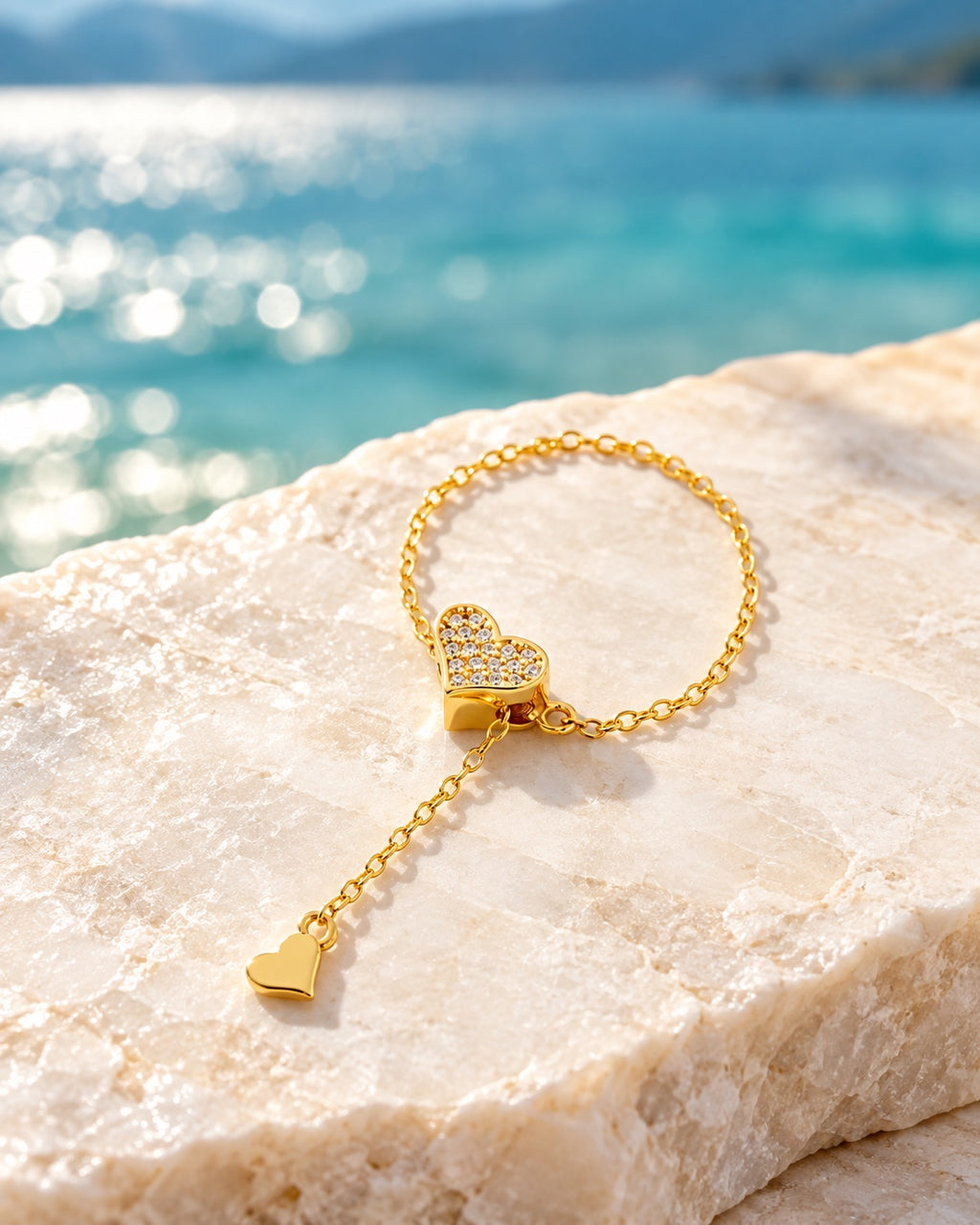Gold heart chain ring on light stone by the lake