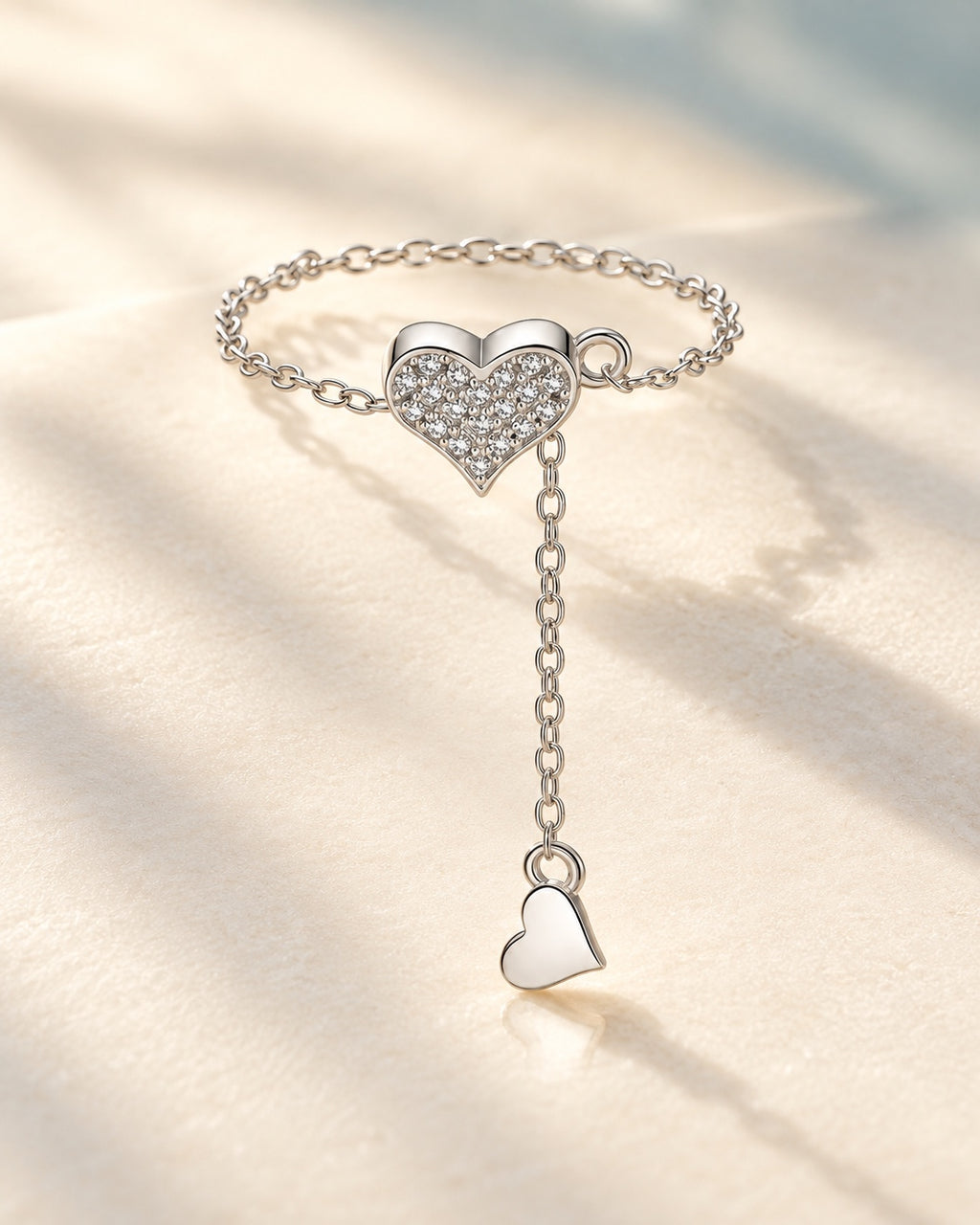Silver pavé heart chain ring on ivory background