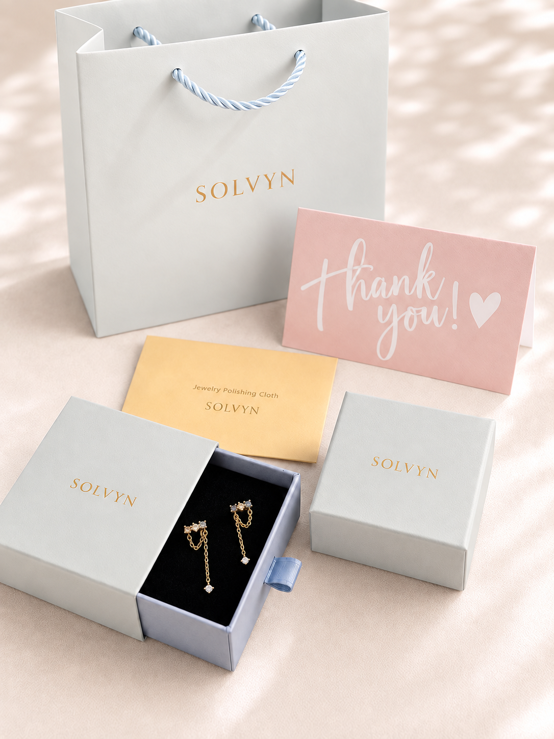 SOLVYN gift packaging with Mira colourful gold chain drop earrings presented in an open jewelry box